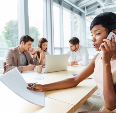 serious-businesswoman-with-documents-talking-on-P9Q6LX6@2x-402x391